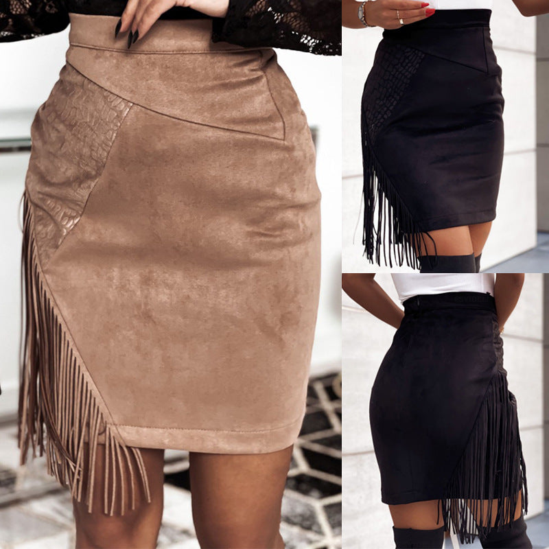 Brown suede skirt with fringe on one side and black fringed skirt on the other, worn by a person.